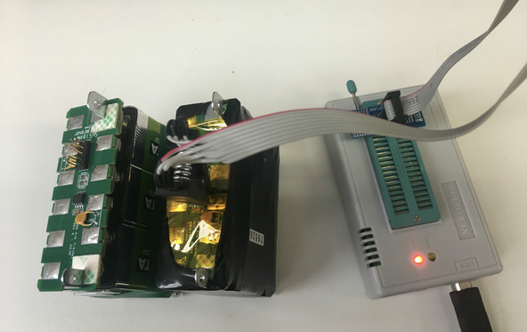 Two battery modules with the programmer attached to one's EEPROM